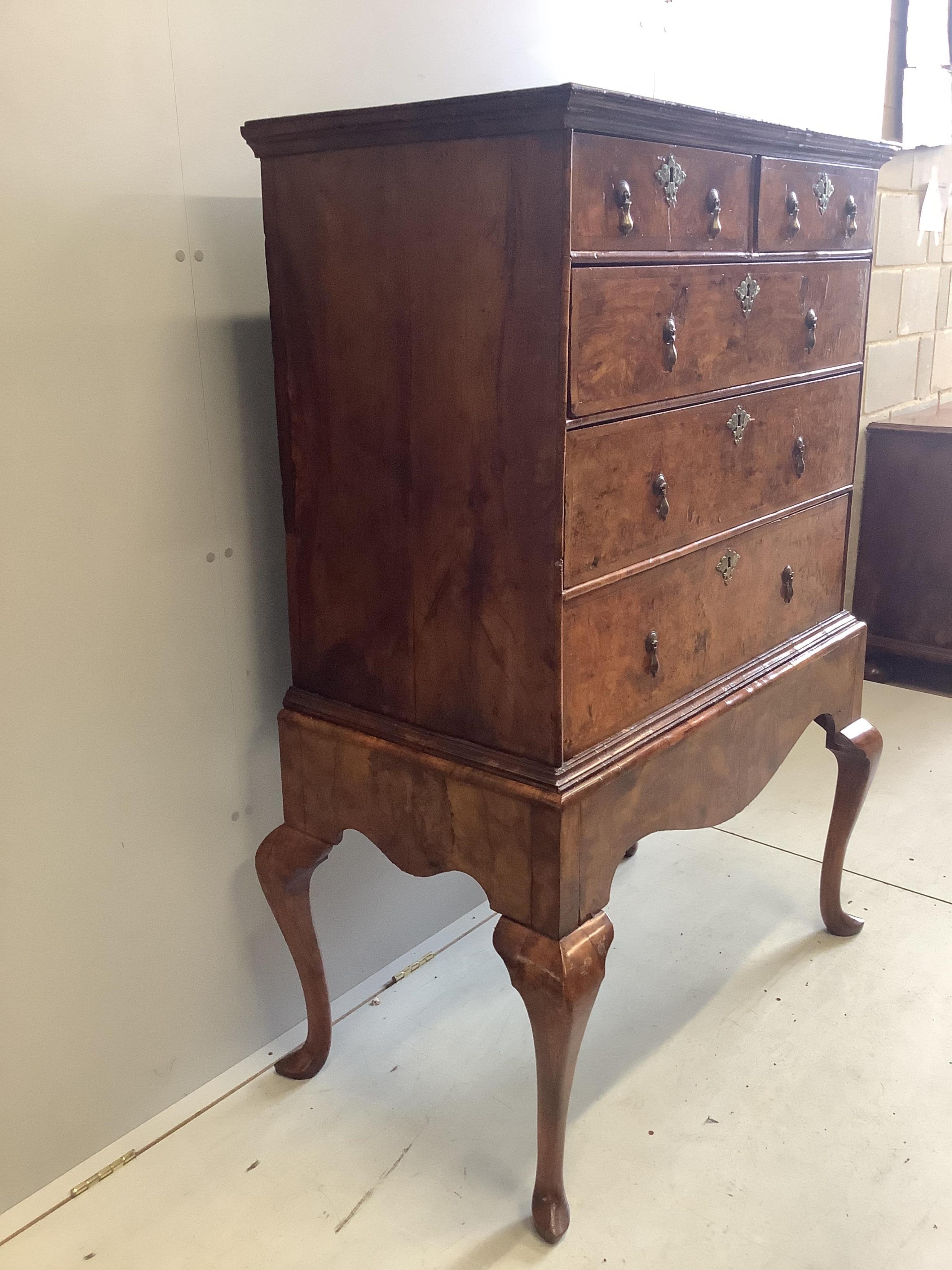 An early 18th century walnut chest on stand, width 98cm, depth 53cm, height 148cm. Condition - fair to good